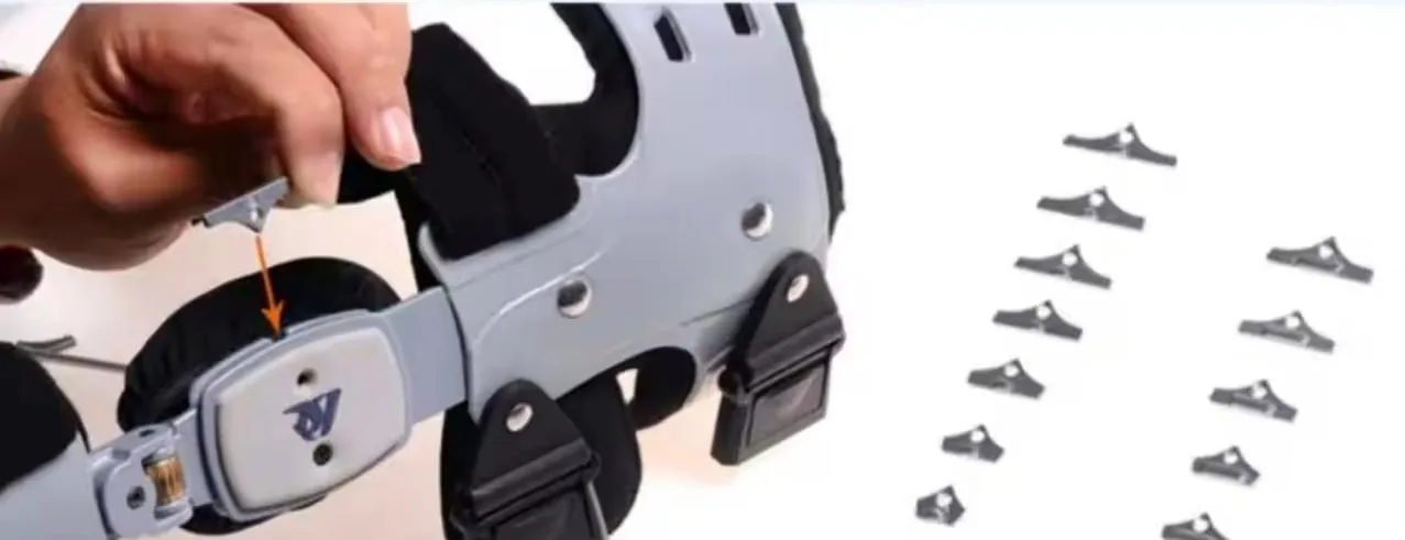 Angle adjustment block being slotted into the OA Knee Brace hinge, with more blocks beside it