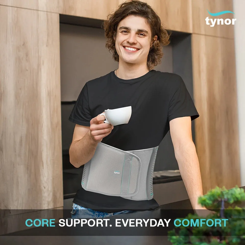 Smiling young man in a black T-shirt holding a white cup, wearing the Tynor Abdominal Support 9 Inch