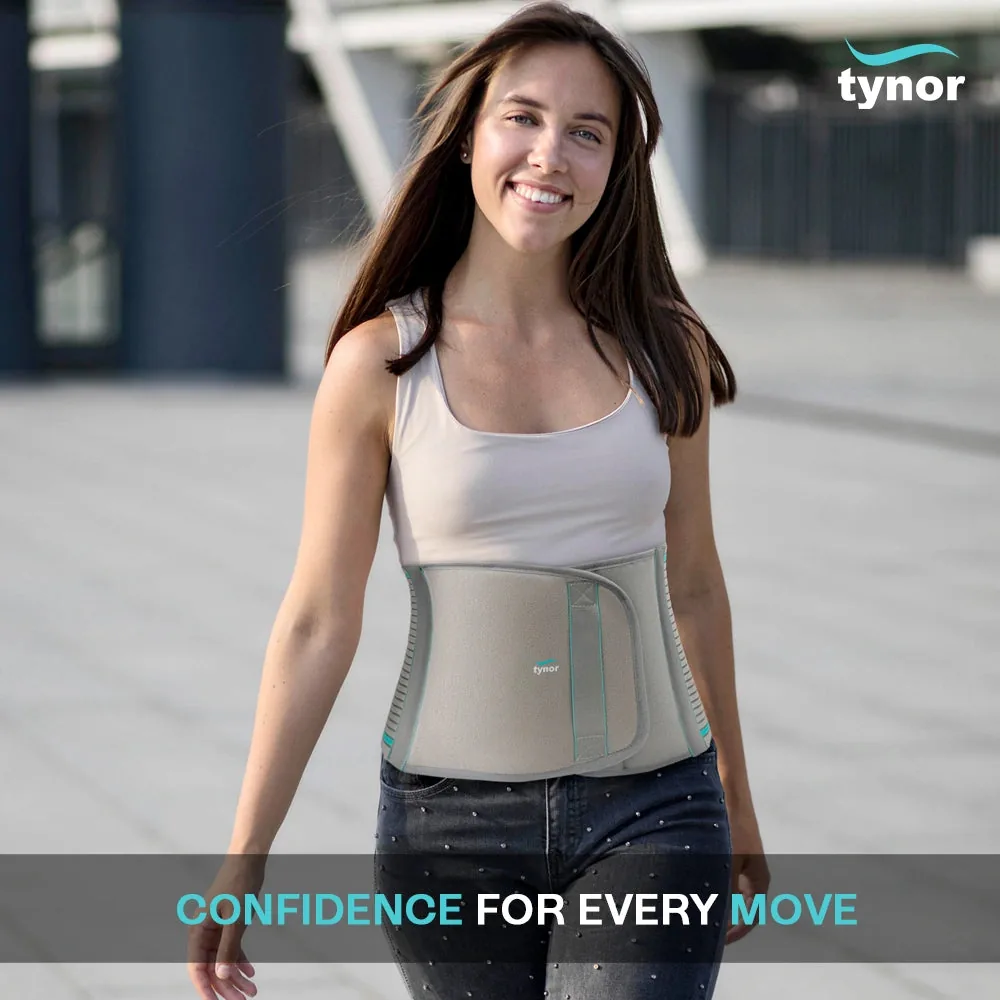 Smiling woman in a white vest top walking outdoors, wearing the Tynor Abdominal Support 9 Inch