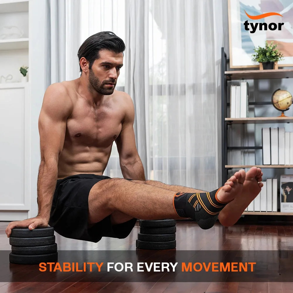 Man doing an L-sit on weight plates at home, wearing the Tynor Ankle Binder Air Pro on one ankle