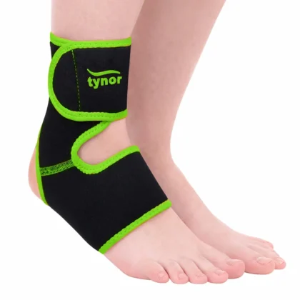 Tynor Ankle Support (Neo) in black with green edging worn on the ankle, showing the wrap strap and open heel