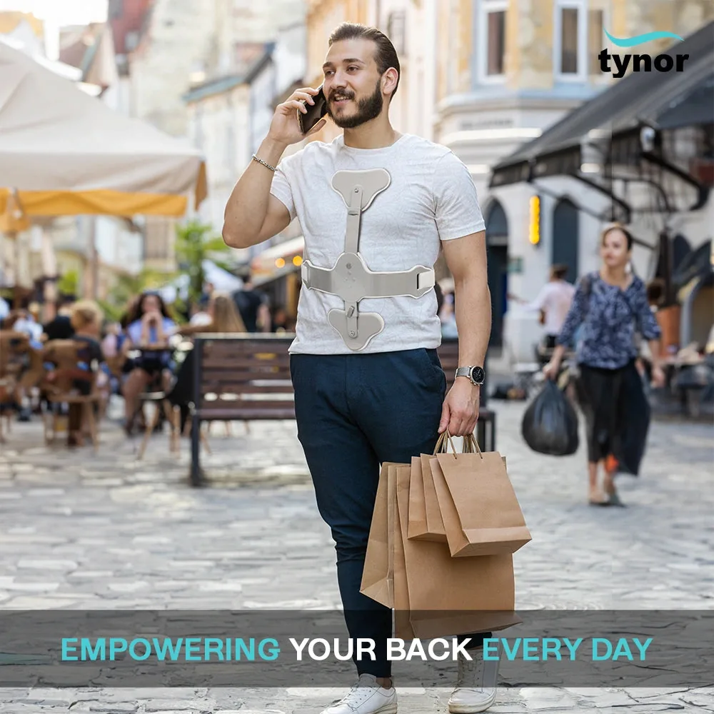 Man walking down a street with shopping bags while wearing the Tynor Ash Brace (Hyper Extension Brace)