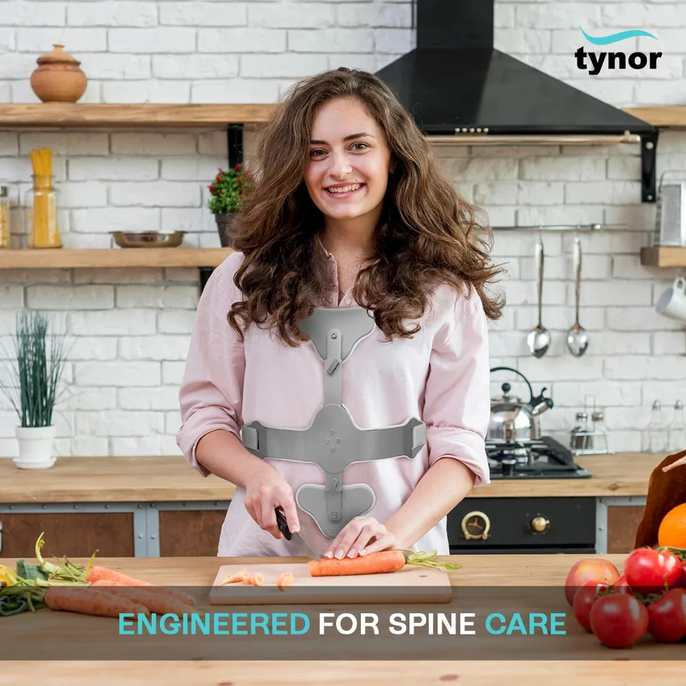 Woman chopping vegetables in a kitchen while wearing the Tynor Ash Brace (Hyper Extension Brace)