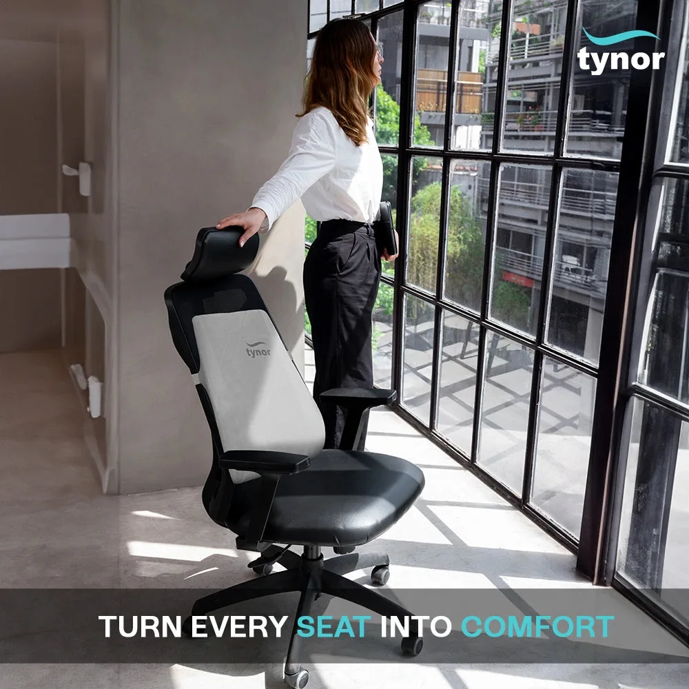 Woman standing by a window beside an office chair fitted with the Tynor Back Rest Full
