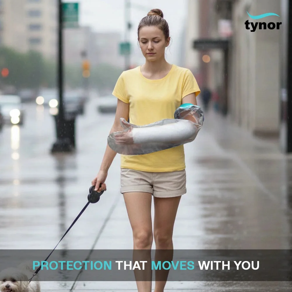 Woman walking a dog in the rain, wearing the Tynor Cast Cover Arm