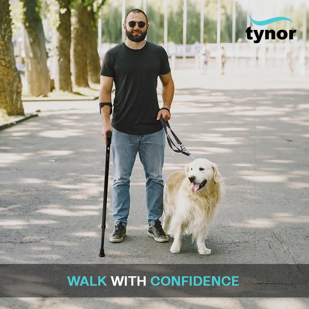 Man walking a dog outdoors, using the Tynor Elbow Crutch Adjustable