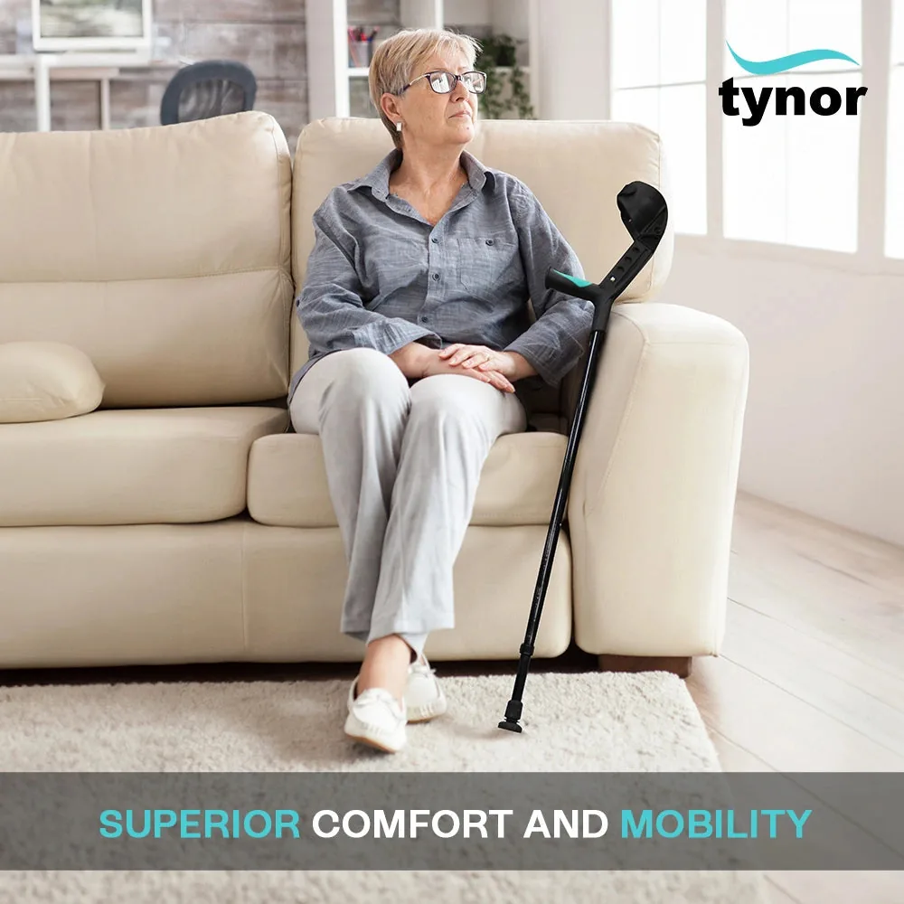 Woman seated on a sofa with the Tynor Elbow Crutch Adjustable resting beside her