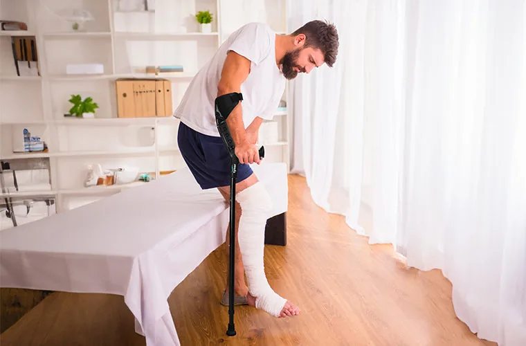 Man getting up from his bed with the Tynor Elbow Crutch Adjustable