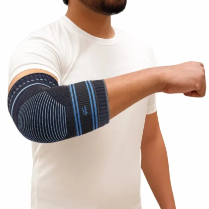 Man in a white T-shirt wearing the Tynor Elbow Support, a striped knit sleeve worn over the elbow