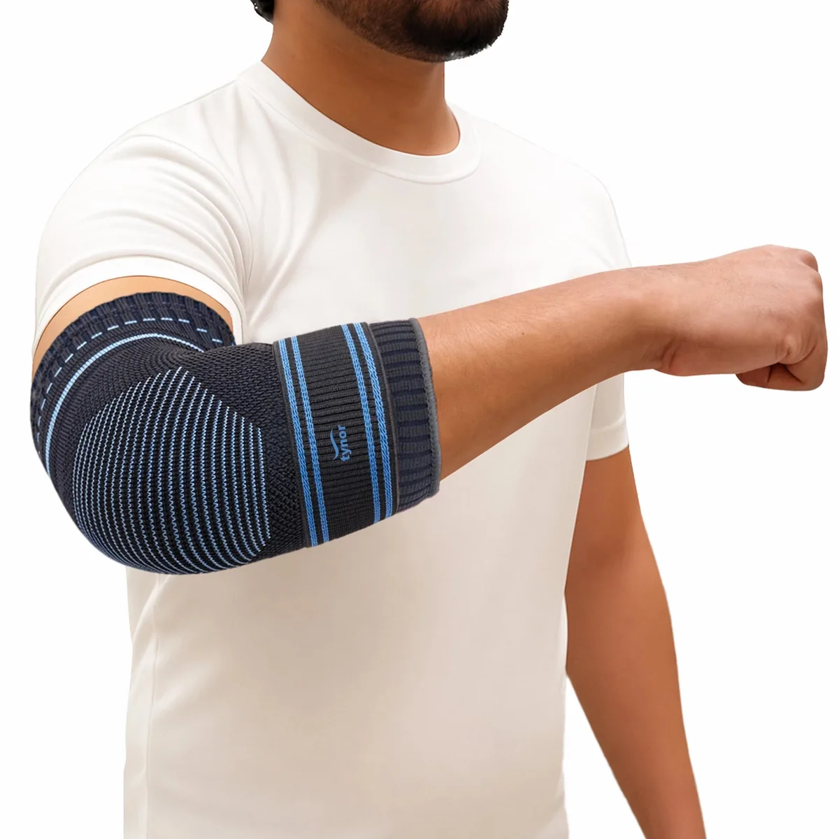 Man in a white T-shirt wearing the Tynor Elbow Support, a striped knit sleeve worn over the elbow