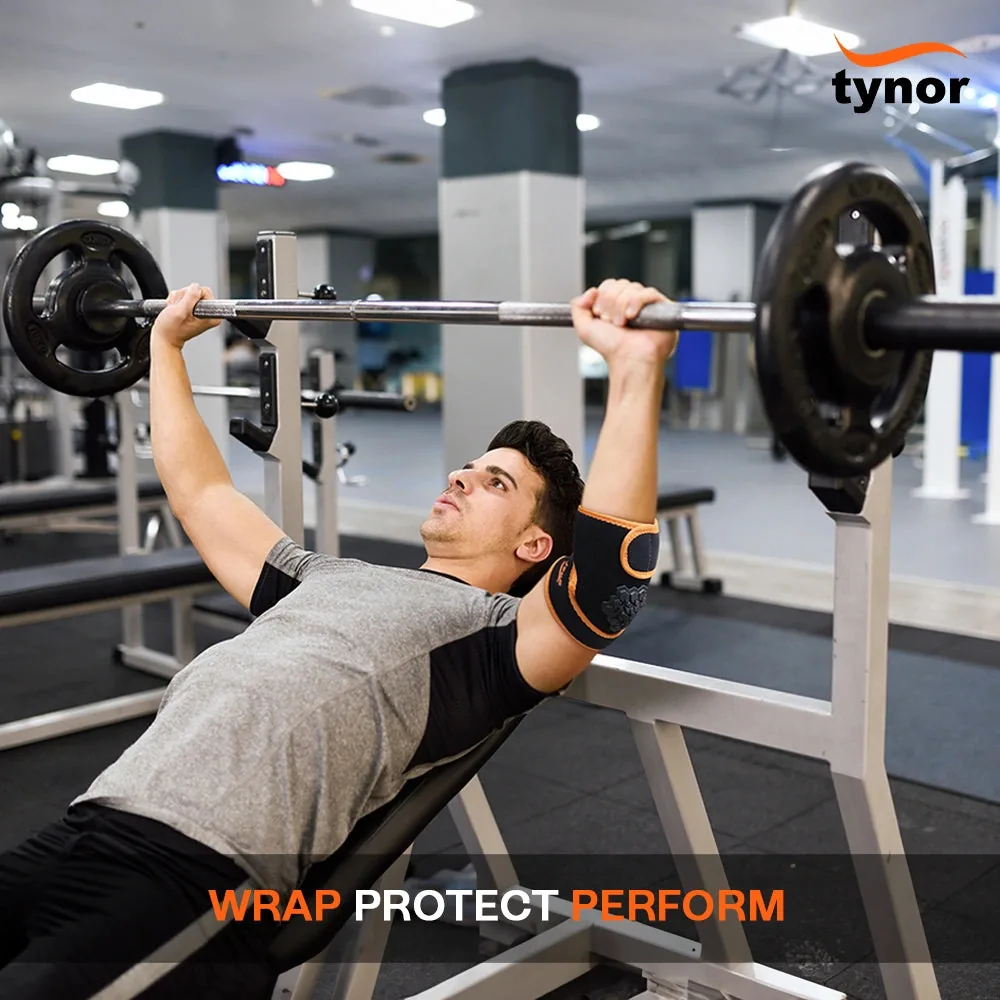 Man doing an incline barbell press wearing the Tynor Elbow Wrap Neo in black and orange