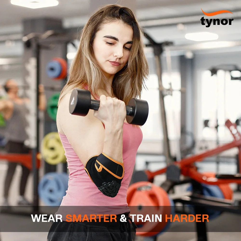 Woman doing a dumbbell curl in a gym wearing the Tynor Elbow Wrap Neo in black and orange