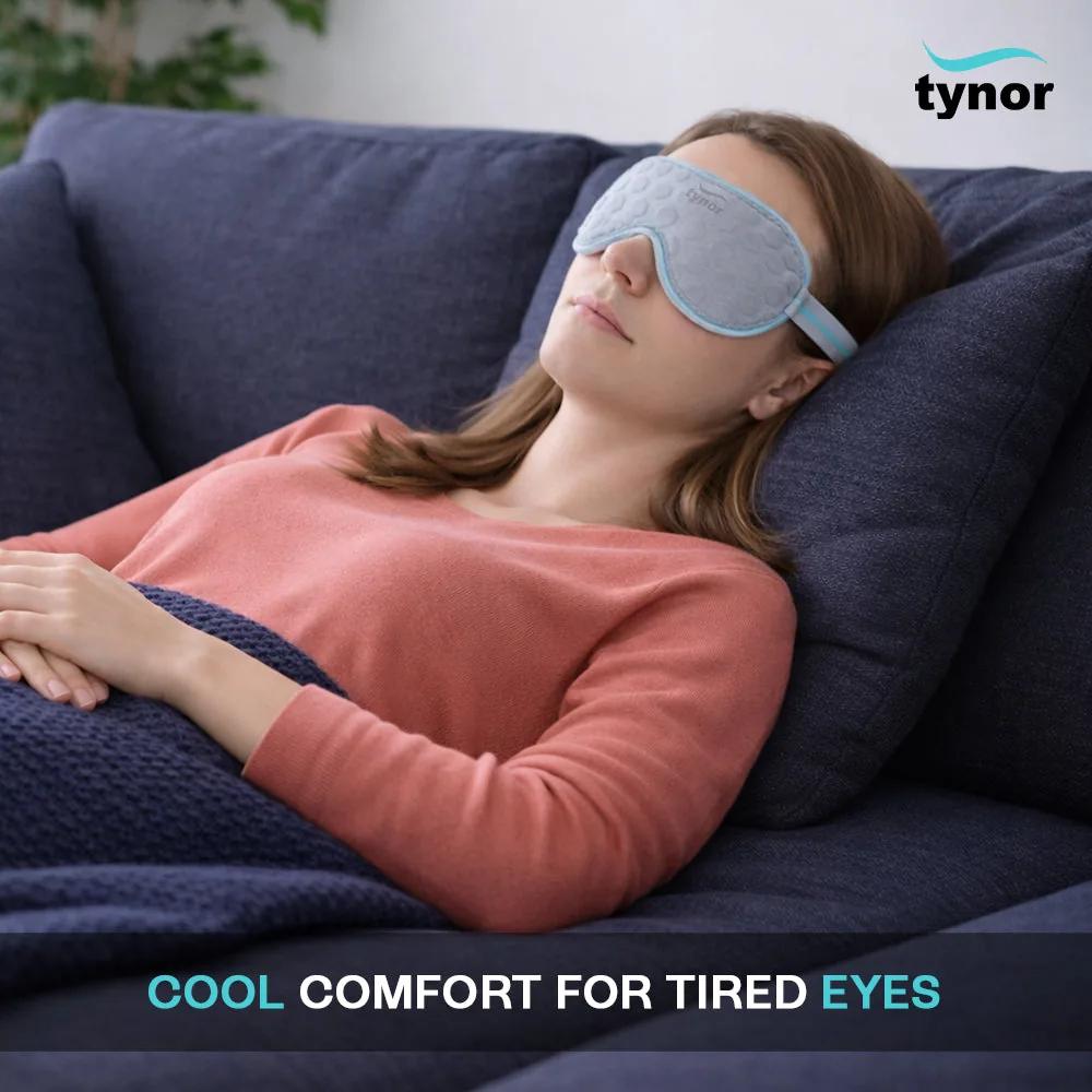 Woman resting on a sofa wearing the Tynor Eye Cool Pack over her eyes
