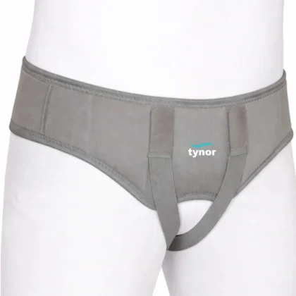 Tynor Hernia Belt in grey on a mannequin, showing the front panel, hook-loop tabs and elastic leg strap