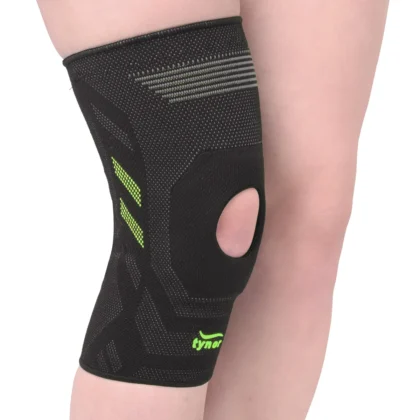 Tynor Knee Cap Air Open Patella in black and green worn on the knee, showing the open kneecap and green knit accents