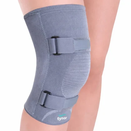 Tynor Knee Cap With Rigid Hinge in grey worn on the knee, front view showing the two hook-and-loop straps