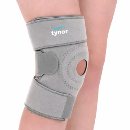 Tynor Knee Wrap (Neoprene) in grey worn on the knee, front view with the patellar opening and hook-loop straps