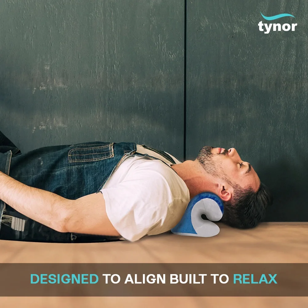 Man lying on his back with his neck resting on the Tynor Neck Corrector & Relaxer