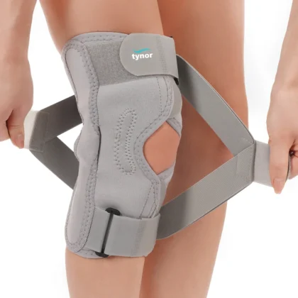 Tynor OA Knee Support (Neoprene) in grey, with its wrap-around straps being fastened around the knee