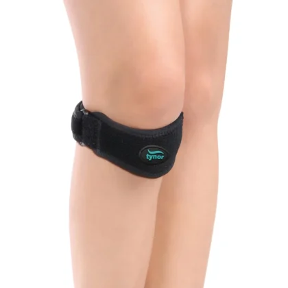 Tynor Patellar Support in black worn just below the kneecap, with the strap tab and buckle at the side