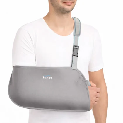 Man wearing the grey Tynor Pouch Arm Sling Baggy with the forearm supported across the chest
