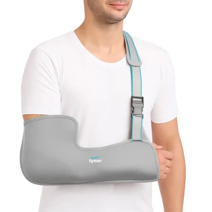 Man in a white T-shirt wearing the grey Tynor Pouch Arm Sling Tropical, with a teal-edged strap and buckle