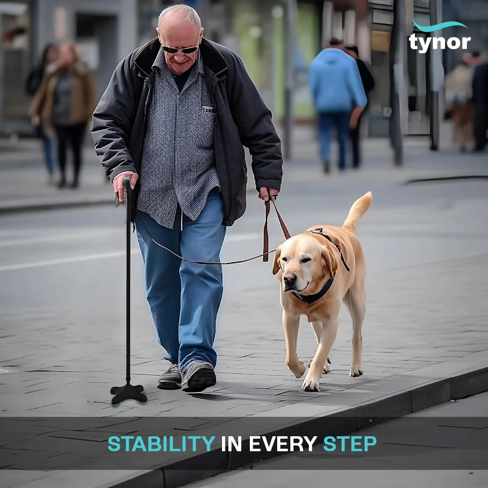 Older man walking his dog on a city pavement using the Tynor Quadra Stick
