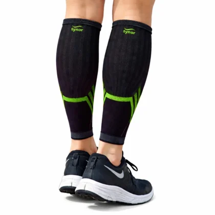 Tynor Shin & Calf Support Air Pro in black and green, worn as a pair with running shoes, back view