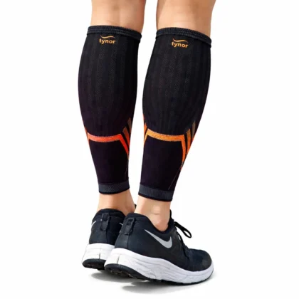 Tynor Shin & Calf Support Air Pro in black and orange, worn as a pair with running shoes, back view