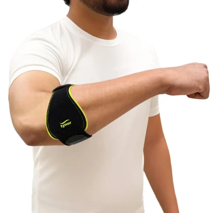 Man in a white T-shirt with his arm stretched forward, wearing the black and green Tynor Tennis/Golfer's Elbow Support Pro