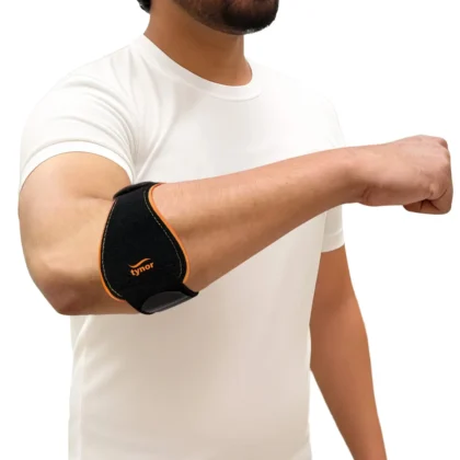 Man in a white T-shirt reaching forward, wearing the black and orange Tynor Tennis/Golfer's Elbow Support Pro on the forearm