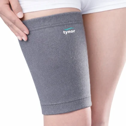 Grey Tynor Thigh Support worn on the upper leg, a hand resting at its top edge