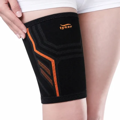 Tynor Thigh Support Air Pro in black and orange, worn on the thigh