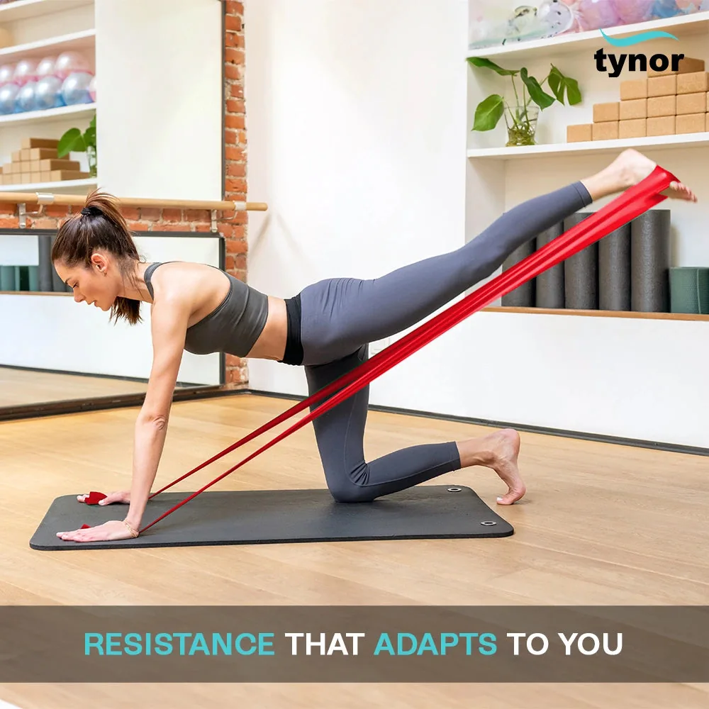 Woman doing a kneeling leg exercise on a mat with a red Tynor Tyroband