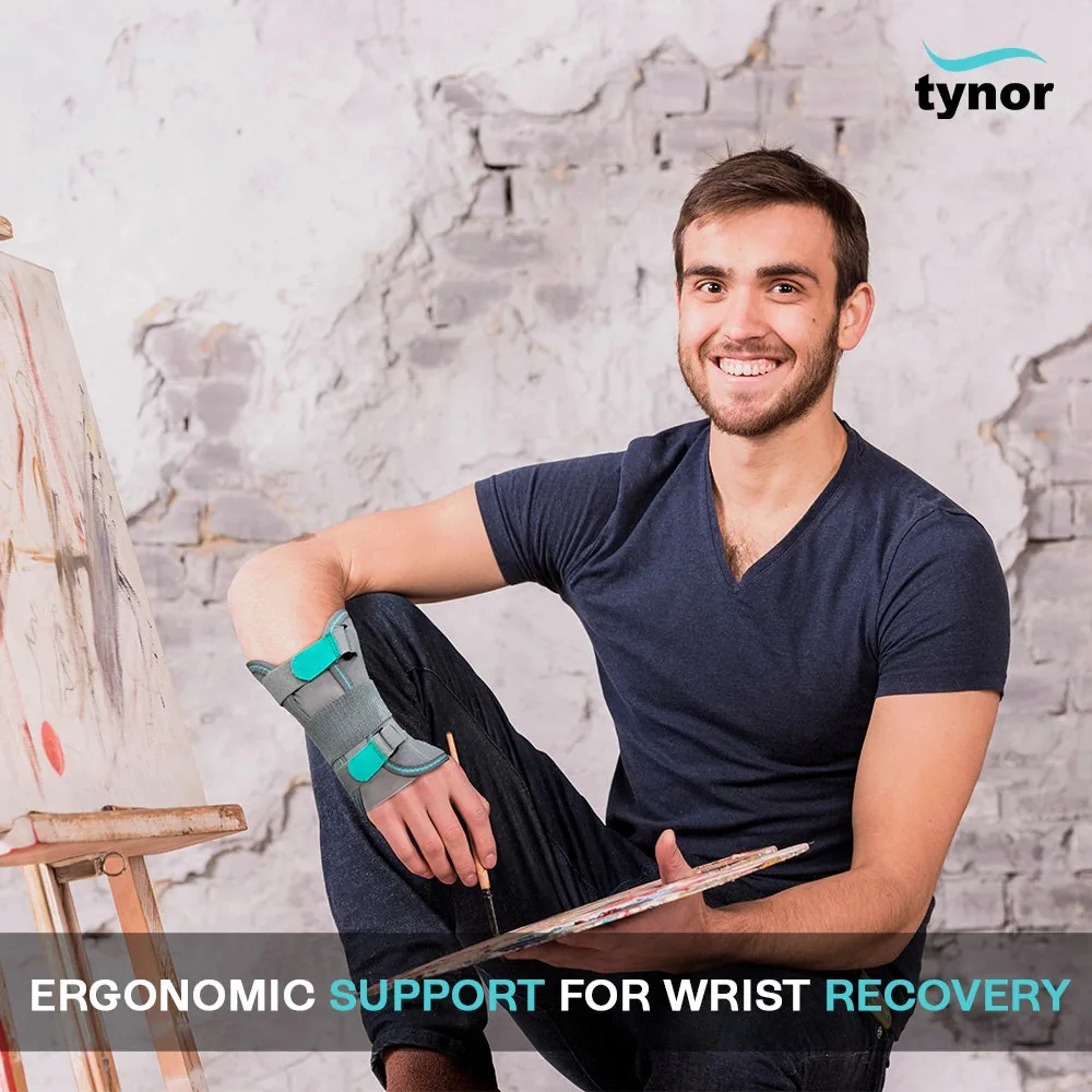 Smiling man holding a paint palette, wearing the Tynor Wrist & Forearm Splint