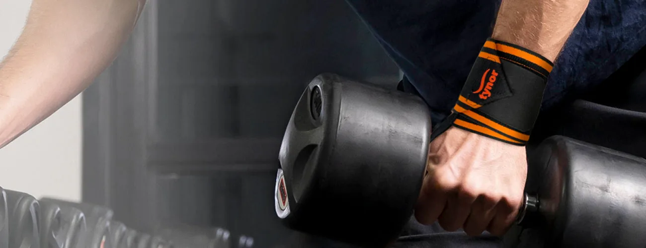 Tynor Wrist Wrap With Thumb Loop close-up: wrapped wrist on a dumbbell